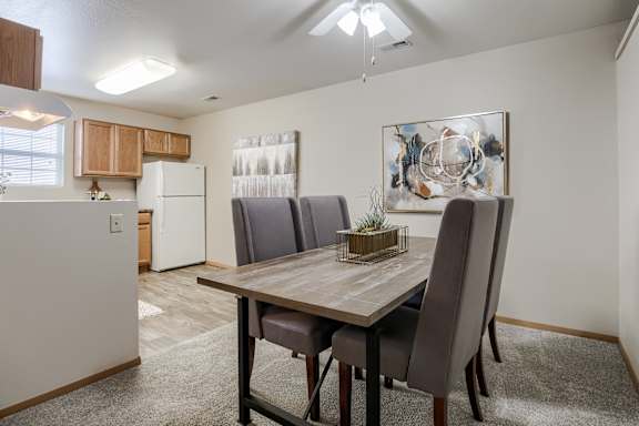 A dining room with a table and chairs. at The Pointe, LaVista, NE