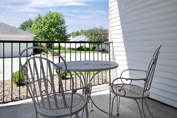A patio with a table and two chairs. at Standing Bear Lake, Omaha