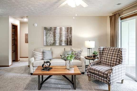 A living room with a couch, chair, and coffee table. at The Pointe, LaVista, NE