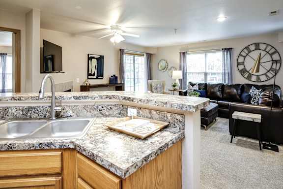 A kitchen with a marble countertop and a ceiling fan. at Tranquility Pointe, Nebraska