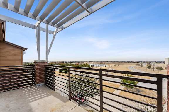 Private balcony with pergola and open views at Gateway Cedars Apartments, Forney, TX 75126