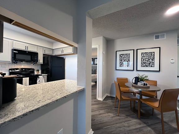 Kitchen with granite breakfast bar and dining area at Ashwood Park Apartments, Texas, 75252