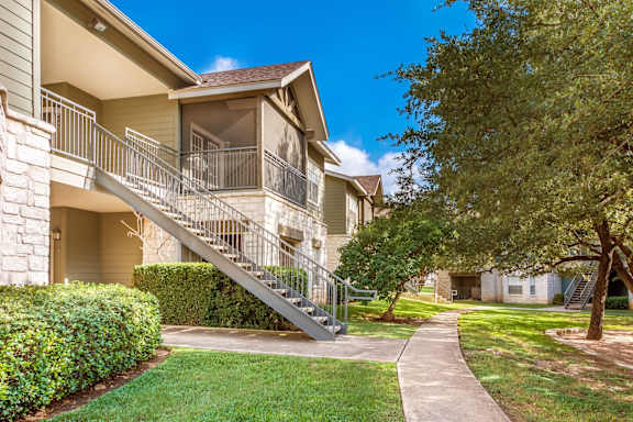 A residential building with a staircase leading to the entrance.