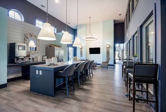 A modern kitchen with a long table and chairs.