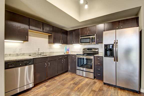 Modern kitchen with stainless steel appliances at Gateway Cedars Apartments, Texas, 75126