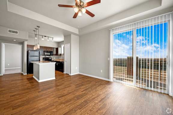 Open living area with hardwood floors and ceiling fan at Gateway Cedars Apartments, Forney, TX 75126