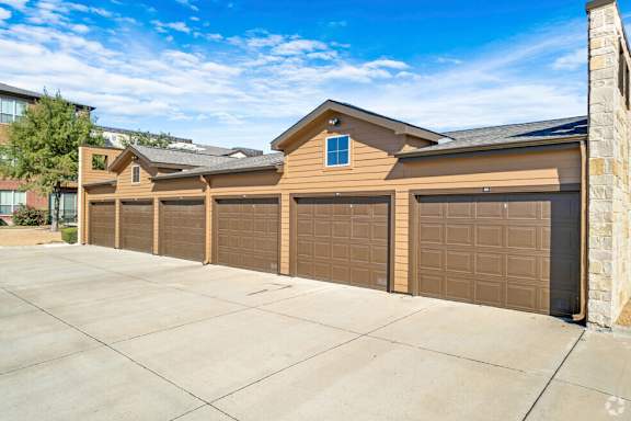 Detached garages with multiple parking bays at Gateway Cedars Apartments, Forney, 75126