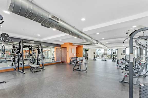 Fitness center with weight equipment and cardio machines at Gateway Cedars Apartments, Texas