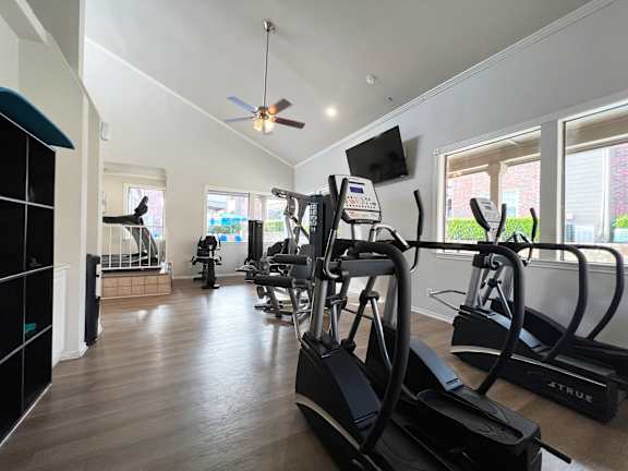 Fitness center with treadmills and weight machines at Ashwood Park Apartments, Dallas, TX