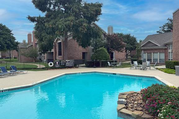 Swimming pool with sundeck and lounge chairs at Indian Creek Apartments, Waxahachie, 75165
