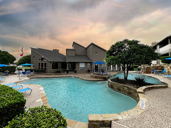Resort style pool with clubhouse and stone accents at Ashwood Park Apartments, Dallas
