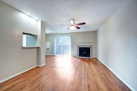 A room with a fireplace and a ceiling fan.