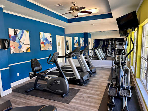 Fitness room with treadmills and elliptical machines at Riviera Apartments, Texas, 76708