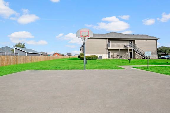 Private basketball court with hoop and residential views at Riviera Apartments, Waco, Texas