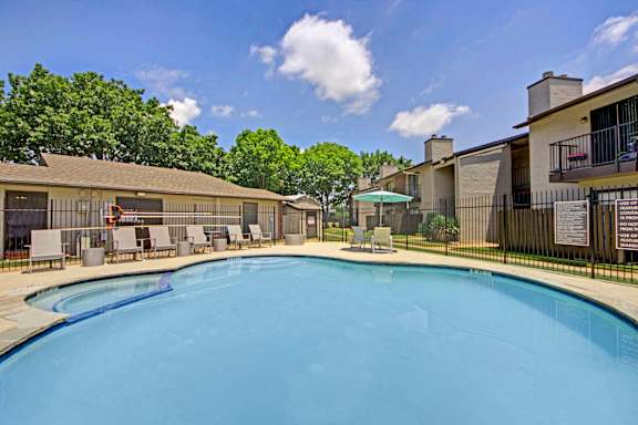 Pool area with lounge chairs and cabana at South Meadows Apartments, Texas, 75154