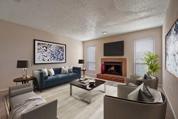 A living room with a fireplace and a painting on the wall.