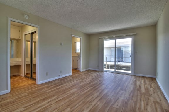 Bright living room with hardwood style floors at Ranchero Plaza, San Jose, 95117