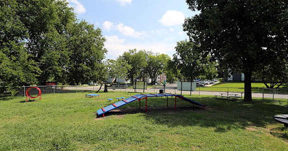 A playground with a slide and a trampoline.