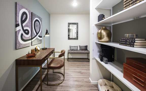 A modern living room with a wooden table and a brown leather chair.