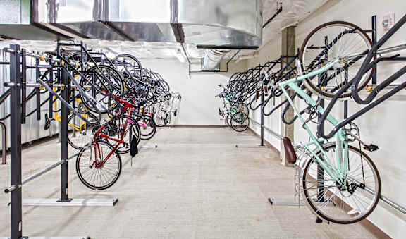 A bike rack with many bicycles parked.