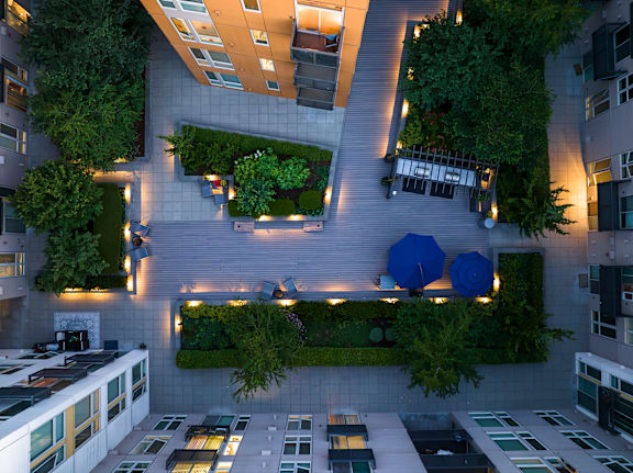 A modern building with a green roof and plants.