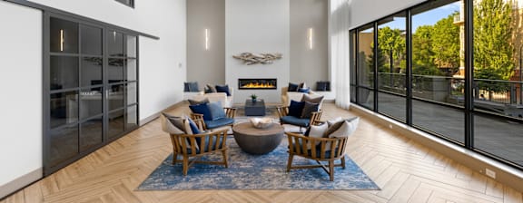 A modern living room with a fireplace and a view of the outside.