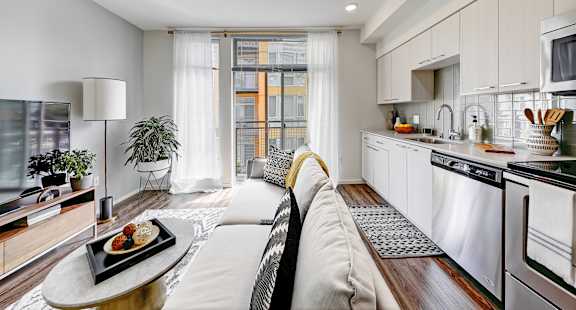 A modern kitchen with a dining table and chairs.