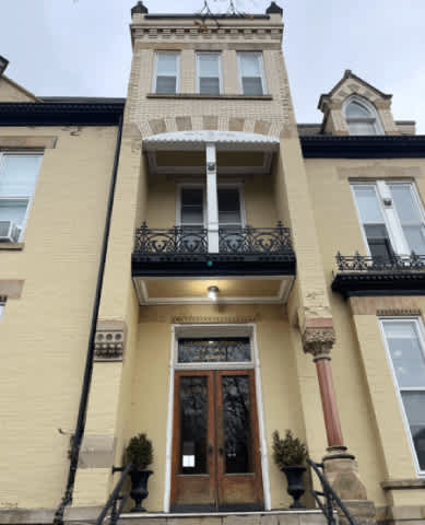 A building with a balcony and a door.