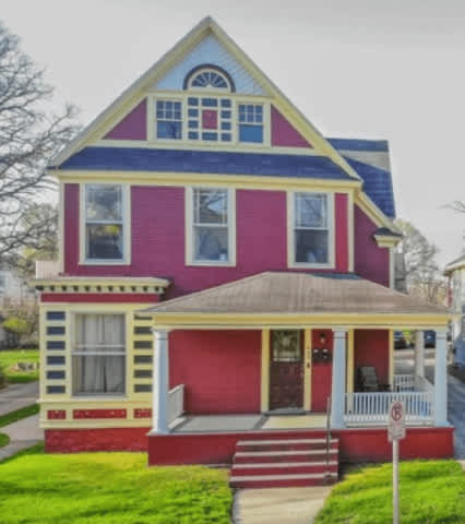 A two-story house with a red and blue exterior.
