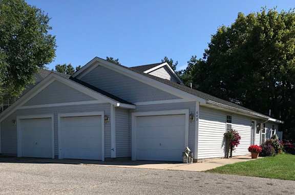 A two-car garage with a white exterior and a grey roof.
