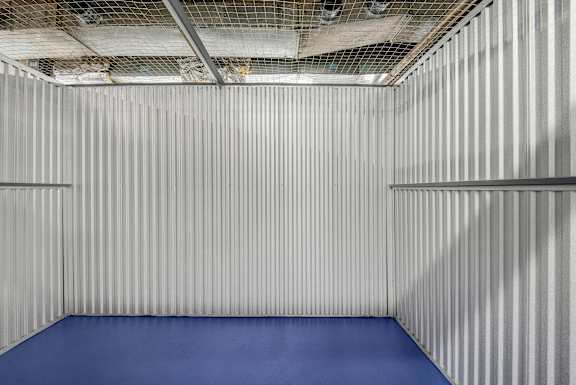 A room with a blue floor and silver walls.
