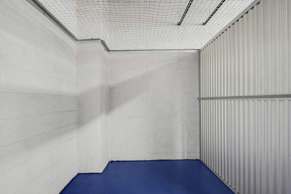 A room with a blue floor and white walls.