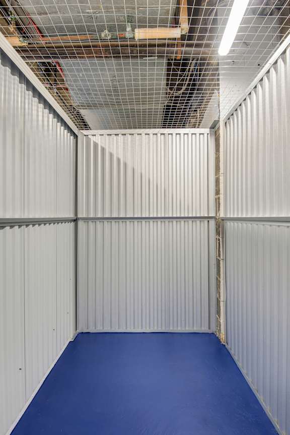 A room with a blue floor and white walls.