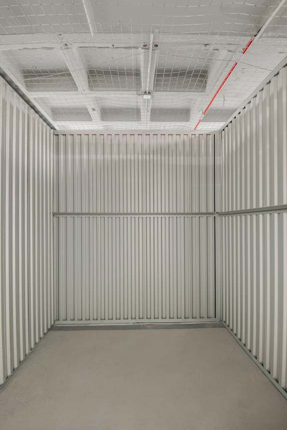 A white room with a striped wall and a ceiling with a grid pattern.