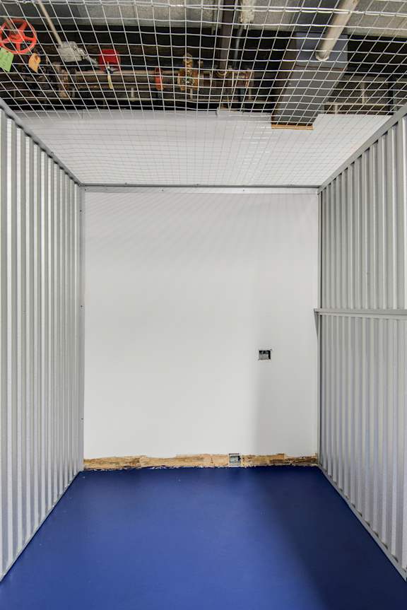 A room with a blue floor and white walls.