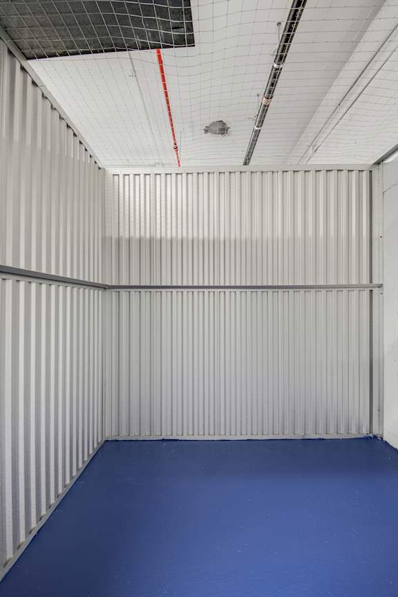 A room with a blue floor and white walls.