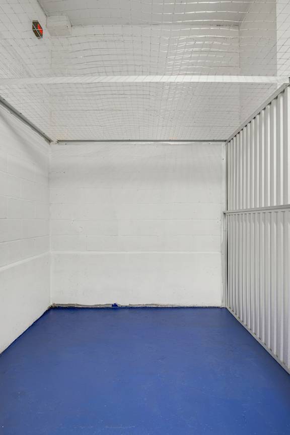 A white room with a blue floor and a white ceiling.
