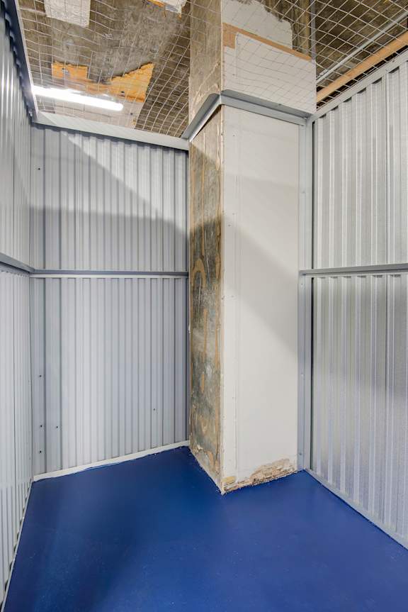 A room with blue flooring and white walls.