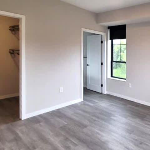 A room with a grey floor and white walls.