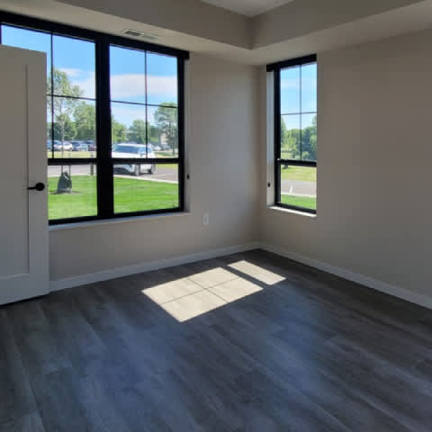A room with a large window and a door.