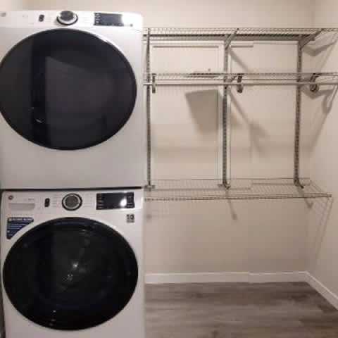 A white dryer is on top of a white washer.