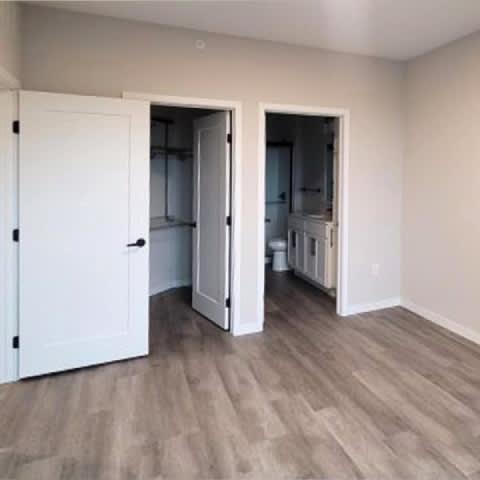 A room with a white door and a white cabinet inside.