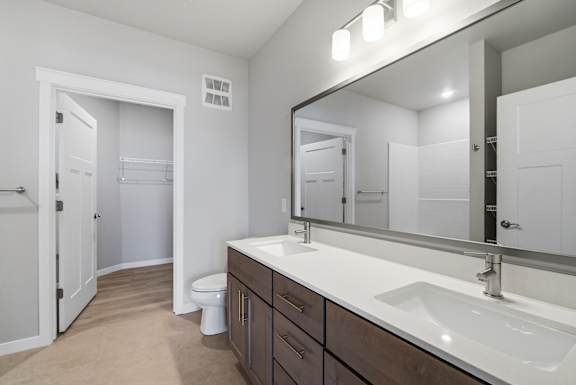 A bathroom with a white sink and a mirror.