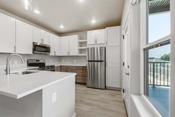 A modern kitchen with white cabinets and a large island.