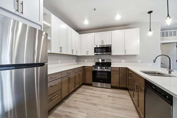 A modern kitchen with stainless steel appliances and wooden cabinets.