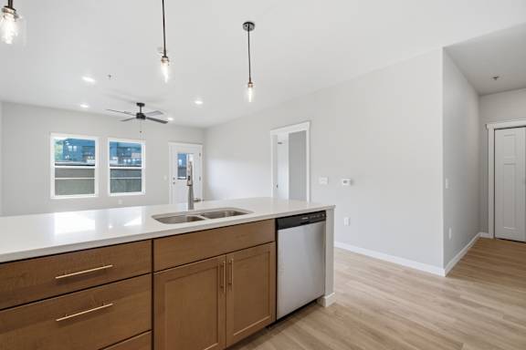 A kitchen with wooden cabinets and a white countertop.