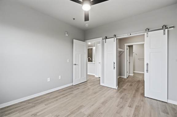 A room with white walls and a ceiling fan.