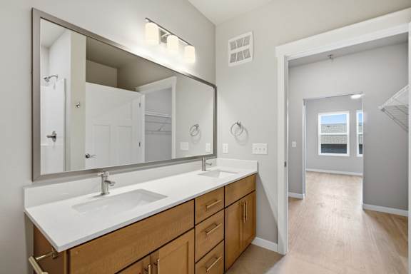 A bathroom with a sink and mirror.