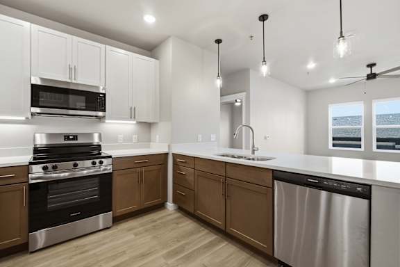 A modern kitchen with wooden cabinets and stainless steel appliances.
