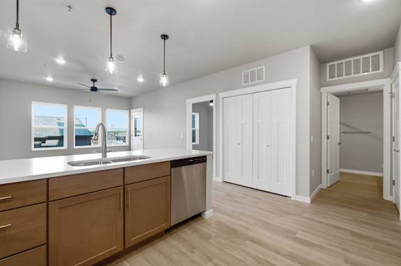 A kitchen with wooden cabinets and a white countertop.